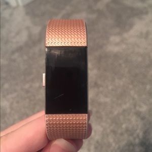 Fitbit Charge 2 with rose gold band and 2 chargers